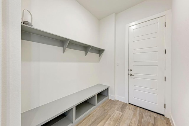 mudroom with light wood finished floors and baseboards