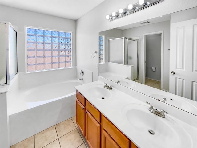 3128 Flinders Reef Ln, Austin, TX 78728 - full bathroom with a garden tub, a stall shower, double vanity, and tile patterned flooring