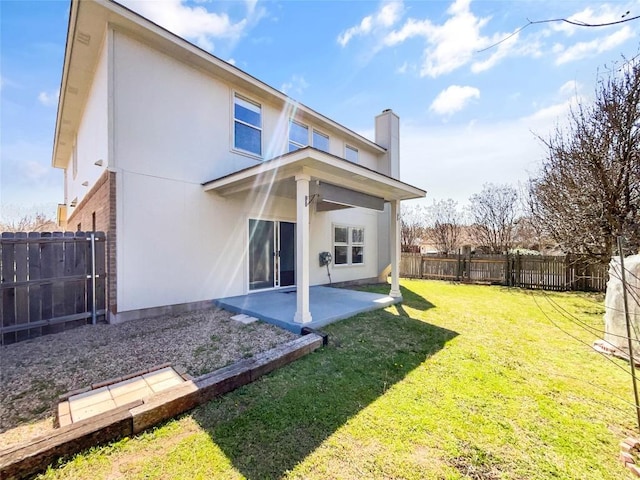 3128 Flinders Reef Ln, Austin, TX 78728 - rear view of house with stucco siding, a patio, a fenced backyard, and a chimney