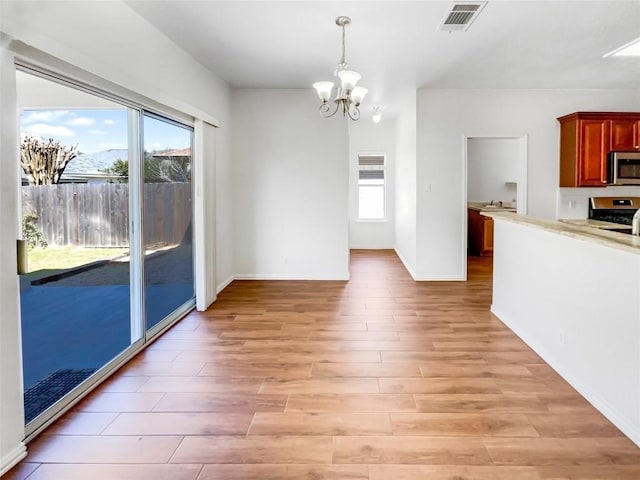 3128 Flinders Reef Ln, Austin, TX 78728 - unfurnished dining area featuring a chandelier and light wood-type flooring