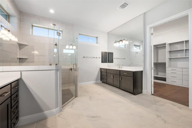 full bathroom with visible vents, marble finish floor, a stall shower, baseboards, and vanity