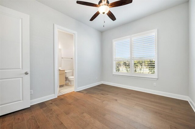 802 Serene Estates Dr, Austin, TX 78738 - unfurnished bedroom with dark wood-type flooring, ensuite bathroom, and ceiling fan