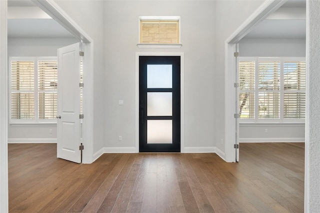 entryway featuring baseboards, plenty of natural light, and hardwood / wood-style flooring