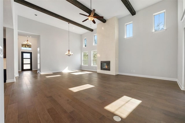 802 Serene Estates Dr, Austin, TX 78738 - unfurnished living room featuring a chandelier, high vaulted ceiling, a tiled fireplace, beam ceiling, and dark wood-type flooring