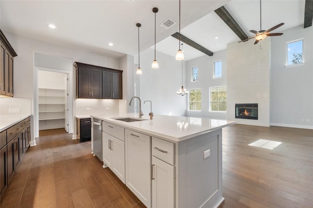 802 Serene Estates Dr, Austin, TX 78738 - kitchen with light countertops, a sink, visible vents, dishwasher, and dark wood-style floors
