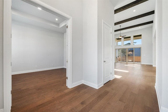 hallway with hardwood / wood-style flooring, beamed ceiling, recessed lighting, and baseboards