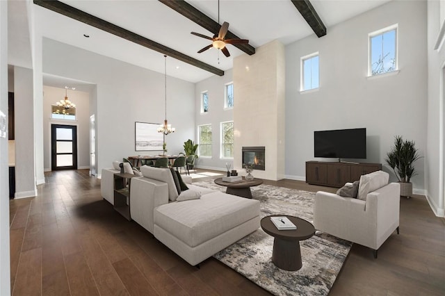 802 Serene Estates Dr, Austin, TX 78738 - living area featuring a chandelier, a towering ceiling, beam ceiling, dark wood-style floors, and a tiled fireplace