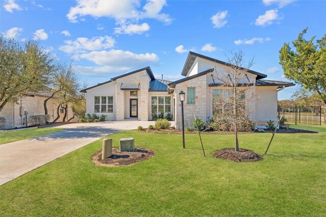 802 Serene Estates Dr, Austin, TX 78738 - view of front of home with stone siding, a standing seam roof, driveway, a metal roof, and stucco siding