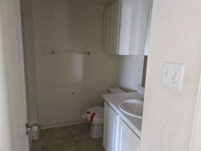 bathroom featuring toilet and vanity