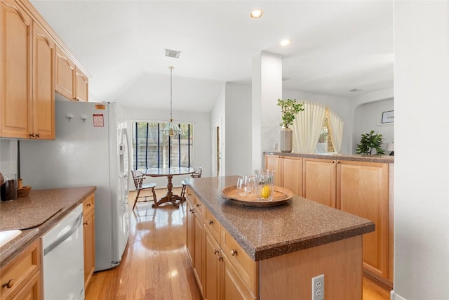 kitchen featuring visible vents, dishwasher, light wood-style flooring, and light brown cabinetry