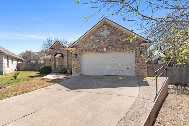 view of front of home with brick siding, a front lawn, fence, concrete driveway, and an attached garage