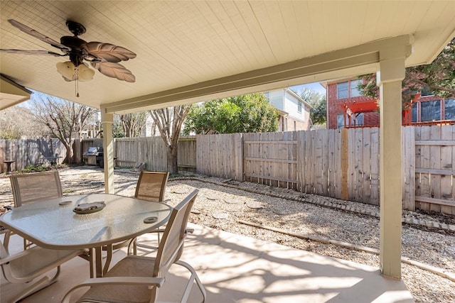 view of patio featuring area for grilling, outdoor dining area, a fenced backyard, and ceiling fan