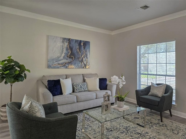 living room featuring visible vents, baseboards, wood finished floors, and ornamental molding