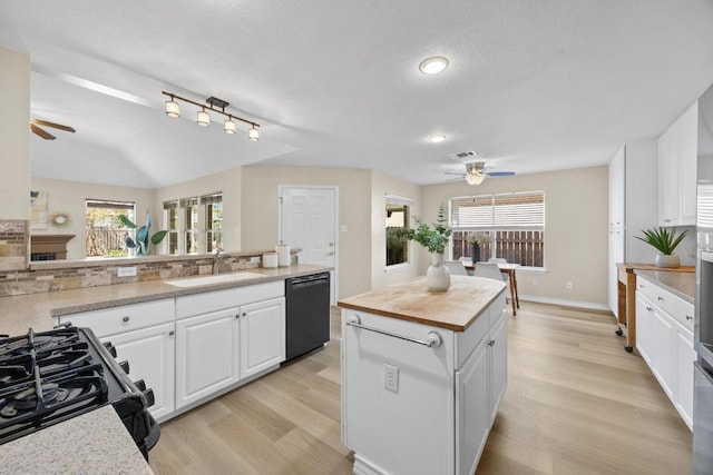 kitchen featuring black appliances, ceiling fan, white cabinetry, wood counters, and a sink