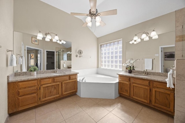 bathroom with tile patterned flooring, vaulted ceiling, two vanities, and a sink