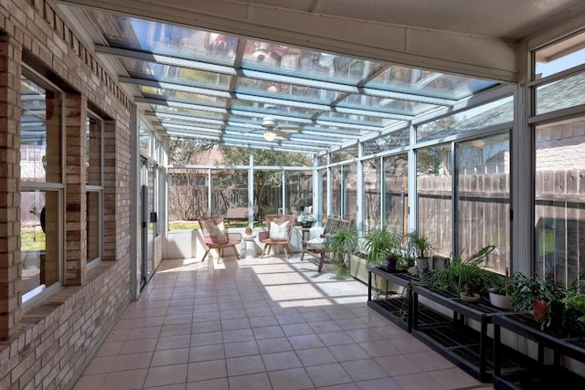 unfurnished sunroom featuring a ceiling fan