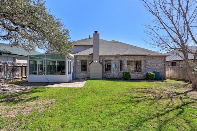 back of property featuring a fenced backyard, a lawn, a sunroom, and a chimney