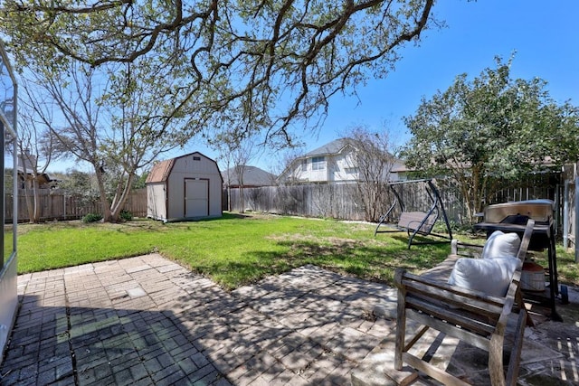 view of yard with a patio area, a shed, a fenced backyard, and an outdoor structure