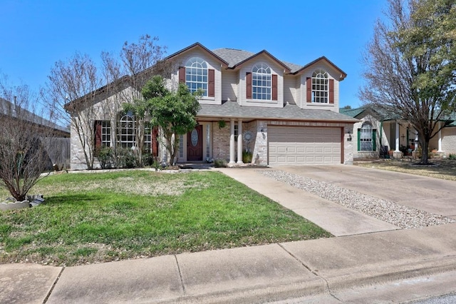 traditional home featuring a front lawn, concrete driveway, a shingled roof, a garage, and brick siding