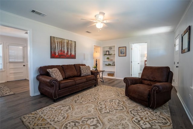 living area featuring crown molding, wood finished floors, and visible vents