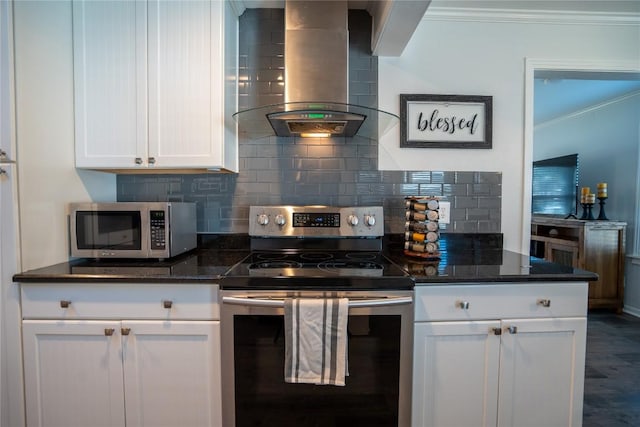 kitchen with backsplash, ornamental molding, appliances with stainless steel finishes, white cabinets, and wall chimney exhaust hood