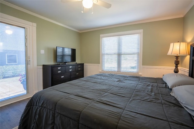 bedroom with ornamental molding, dark wood-style flooring, and wainscoting