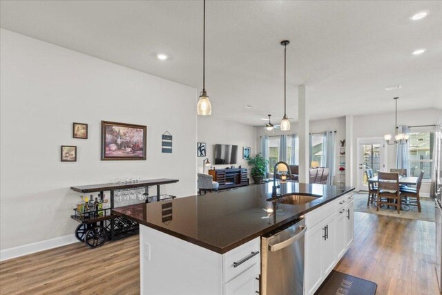 107 Freeman Day Dr, Bastrop, TX 78602 - kitchen featuring a sink, dishwasher, dark countertops, wood finished floors, and recessed lighting