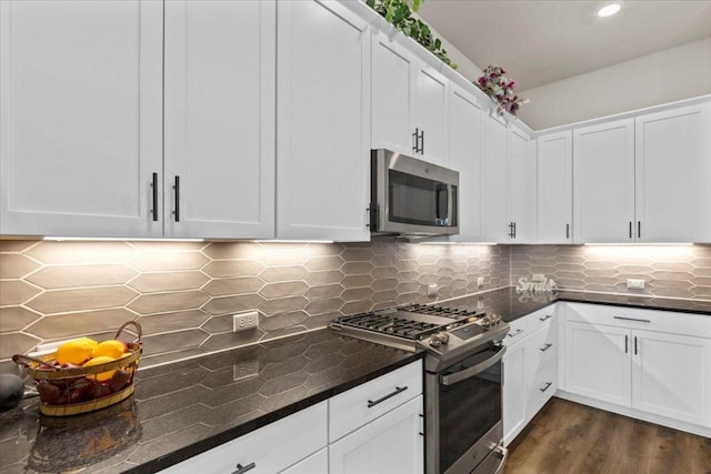 107 Freeman Day Dr, Bastrop, TX 78602 - kitchen with appliances with stainless steel finishes, decorative backsplash, white cabinetry, dark wood-style floors, and recessed lighting