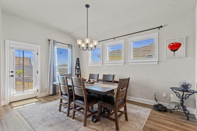 107 Freeman Day Dr, Bastrop, TX 78602 - dining space with a chandelier, wood finished floors, baseboards, and vaulted ceiling