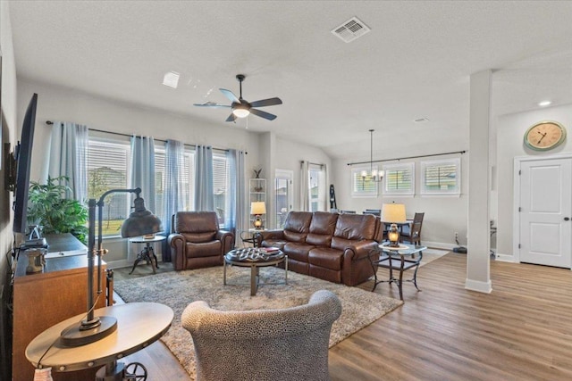 107 Freeman Day Dr, Bastrop, TX 78602 - living room featuring healthy amount of natural light, baseboards, a ceiling fan, wood finished floors, and a textured ceiling
