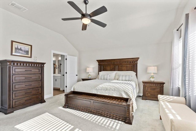 107 Freeman Day Dr, Bastrop, TX 78602 - bedroom with vaulted ceiling, light carpet, baseboards, ensuite bath, and a ceiling fan