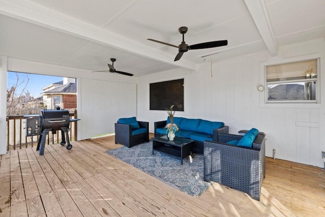 wooden terrace with ceiling fan and an outdoor hangout area