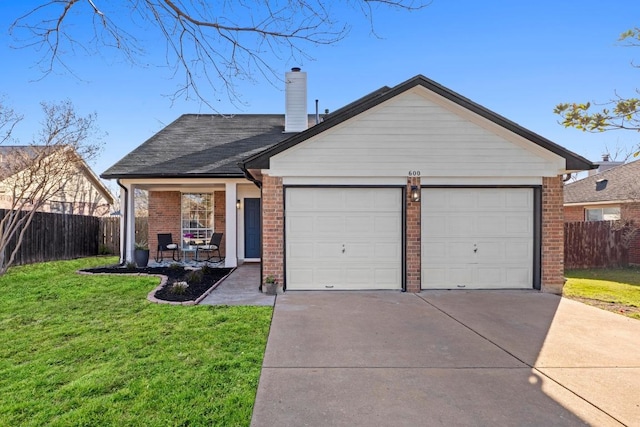 single story home with brick siding, a garage, a front yard, and fence