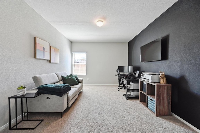 carpeted office space featuring a textured ceiling, baseboards, and a textured wall