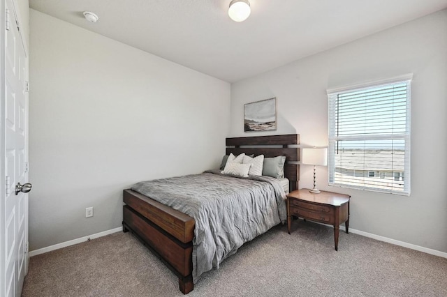 bedroom with baseboards and carpet