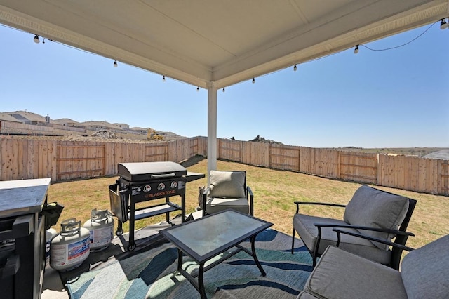 view of patio / terrace with grilling area and a fenced backyard