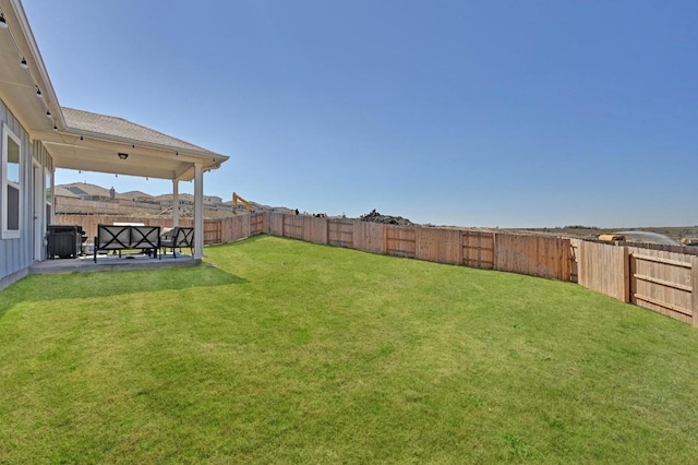 view of yard with a fenced backyard, a patio, and central AC