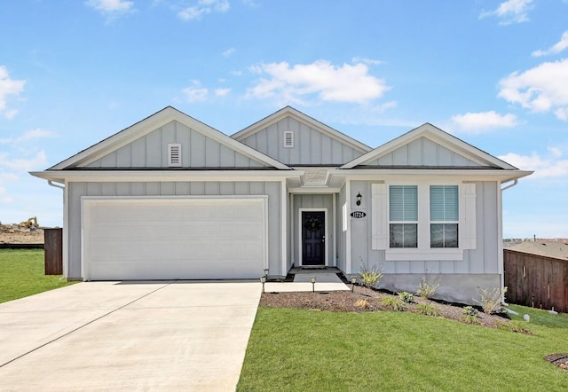 view of front facade featuring concrete driveway, a garage, board and batten siding, and a front yard