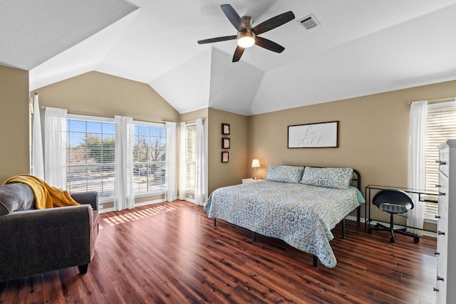 bedroom with vaulted ceiling, multiple windows, wood finished floors, and visible vents