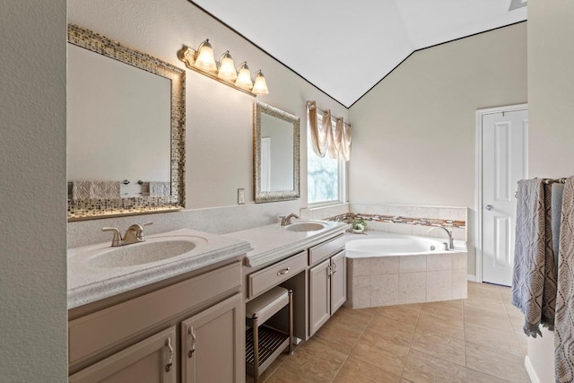 bathroom featuring a sink, tile patterned flooring, double vanity, a bath, and vaulted ceiling