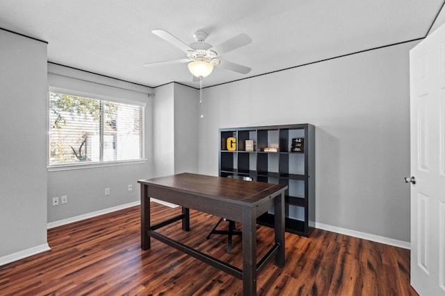 home office with a ceiling fan, baseboards, and wood finished floors