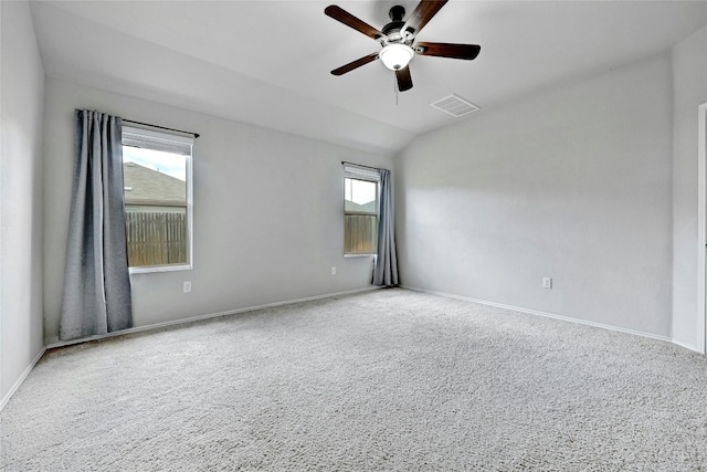 spare room with visible vents, ceiling fan, baseboards, and lofted ceiling