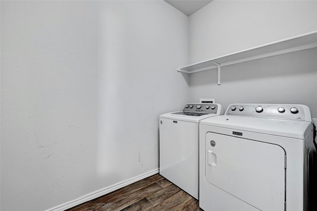 laundry room with laundry area, washing machine and dryer, baseboards, and dark wood-style flooring