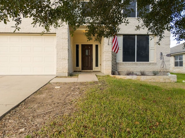 view of front of property featuring a front lawn, brick siding, and driveway