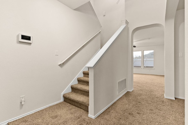 9812 Cow Page Ct, Temple, TX 76502 - stairway with visible vents, arched walkways, carpet, and baseboards