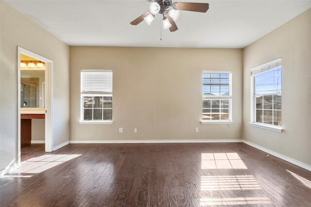 spare room featuring ceiling fan, baseboards, and wood finished floors