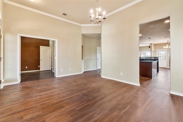 unfurnished room with dark wood-style floors, a notable chandelier, and visible vents