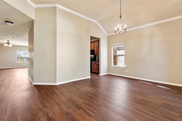 empty room featuring ceiling fan with notable chandelier, crown molding, dark wood-type flooring, and baseboards