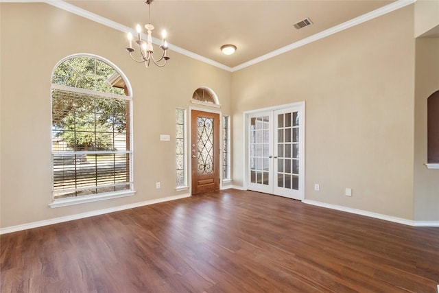 foyer entrance with visible vents, french doors, dark wood-type flooring, and ornamental molding