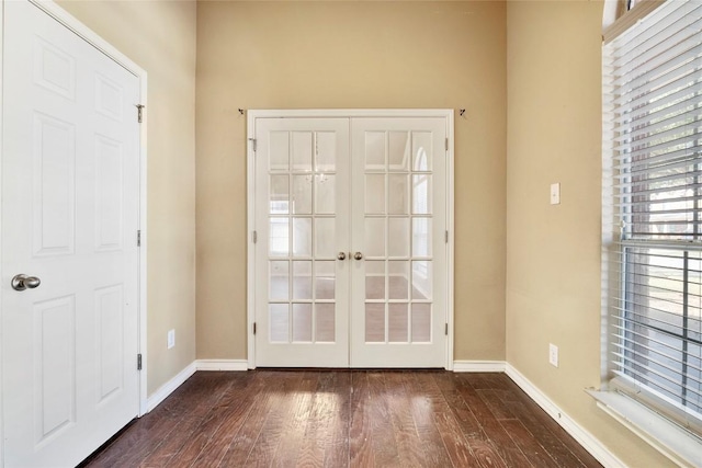 foyer entrance featuring french doors, baseboards, and dark wood-type flooring